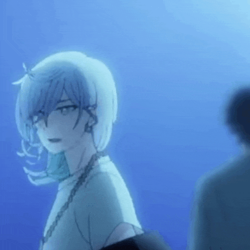 a man and a woman are standing next to each other in a blue room .