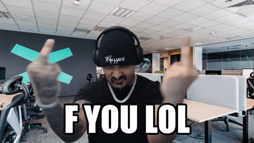 a man wearing headphones giving the middle finger with the words f you lol behind him