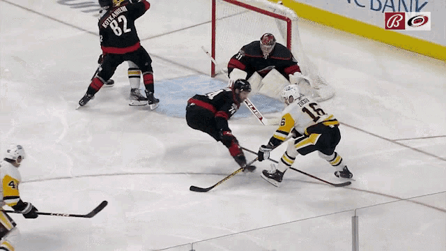 a hockey player with the number 42 on his jersey is being chased by another player