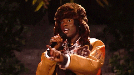 a man wearing a fur hat and a varsity jacket with the number 70 on the sleeve
