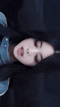 a woman laying on a couch on a subway train