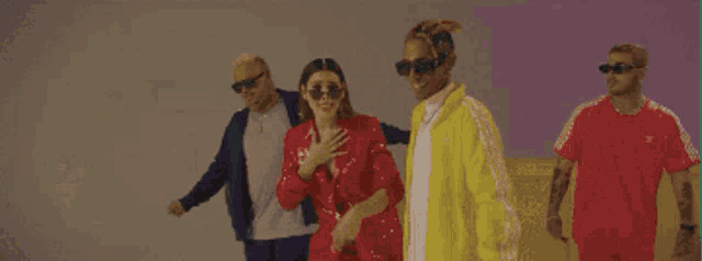 a group of people wearing adidas jackets are dancing together