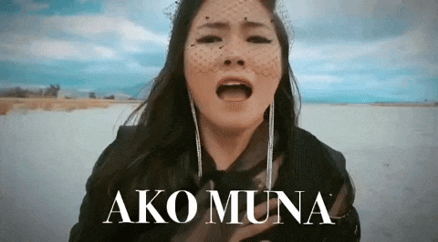 a woman with a veil on her face is singing the song ako muna .