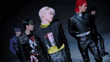 a group of young men are standing in a line and one of them is wearing a shirt that says " i am "
