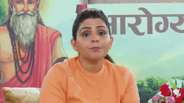 a woman sitting in front of a sign that says ' ayurvedic '