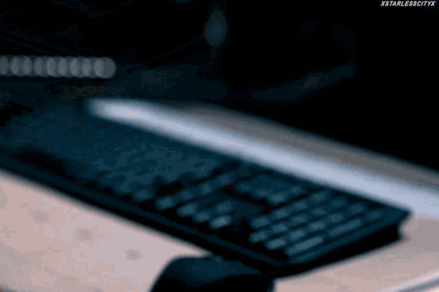a close up of a computer keyboard with xstarlesscityx written on the bottom right
