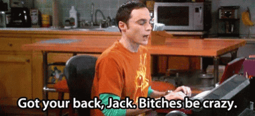 a man in an orange shirt is typing on a keyboard in a kitchen and says got your back jack bitches be crazy .