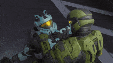 a man in a green helmet is standing next to a man in a blue helmet with cat ears
