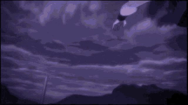 a person 's hand is reaching for a purple object