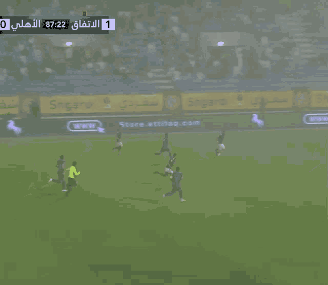 a soccer game is being played in a foggy stadium