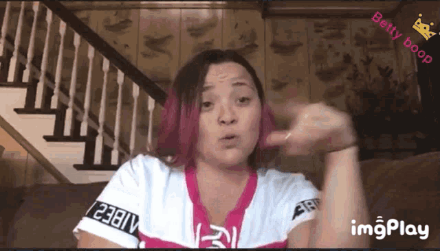 a woman with pink hair and a betty boop logo