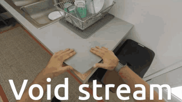 a person is holding a piece of paper in front of a sink with the words " void stream " on the bottom