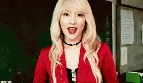 a woman with blonde hair is wearing a red jacket