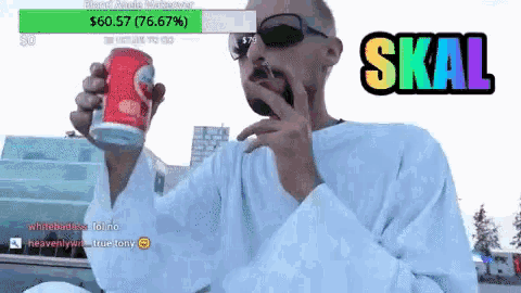 a man holding a can of soda with the word skal on the bottom right