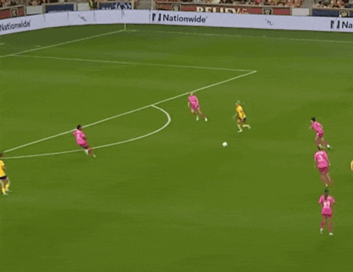 a soccer game is being played in front of a sign that says on and off the pitch