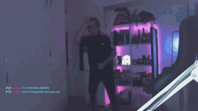 a man is dancing in front of a shelf with the words " it is the real one bro " at the bottom