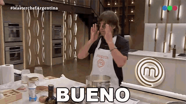 a man in an apron is standing in front of a masterchef logo