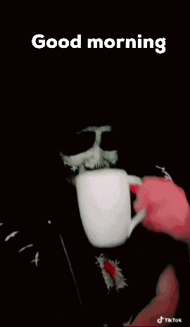 a person with a skeleton face paint is holding a cup of coffee and saying good morning .