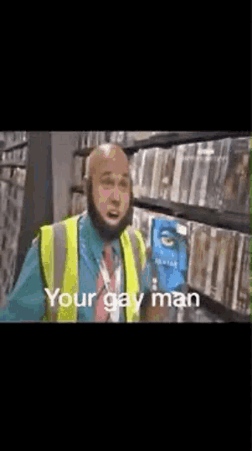 a man with a beard wearing a yellow vest is standing in front of a shelf in a store .