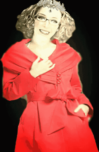a woman wearing glasses and a red coat has a crown on her head