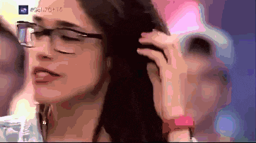 a woman wearing glasses is talking on a cell phone with a watermark that says ' nbc ' on it