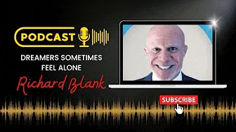 a man is sitting in front of a laptop with a microphone on it .