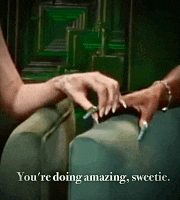 a woman is sitting on a couch holding another woman 's hand with the words you 're doing amazing sweetie .