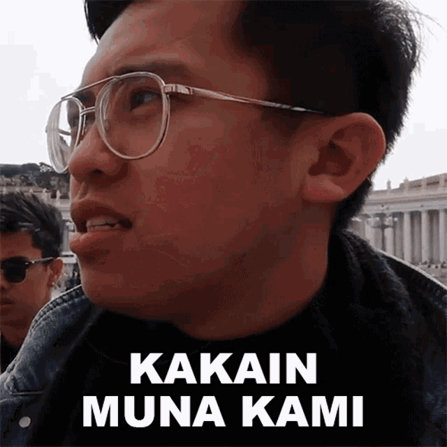 a man wearing glasses has the words kakain muna kami written on his face