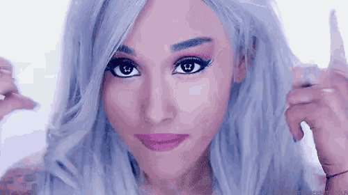 ariana grande is wearing a wig and making a face .