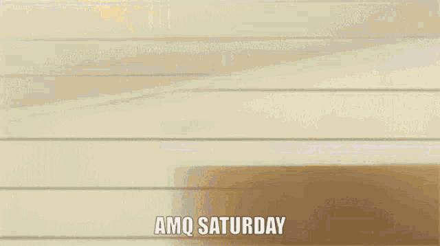 a girl in a white dress is standing in front of a wall with the words amq saturday written on it .