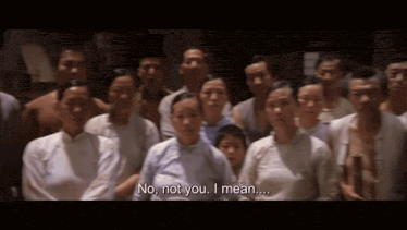 a group of people are standing in a line and one of them says no not you i mean