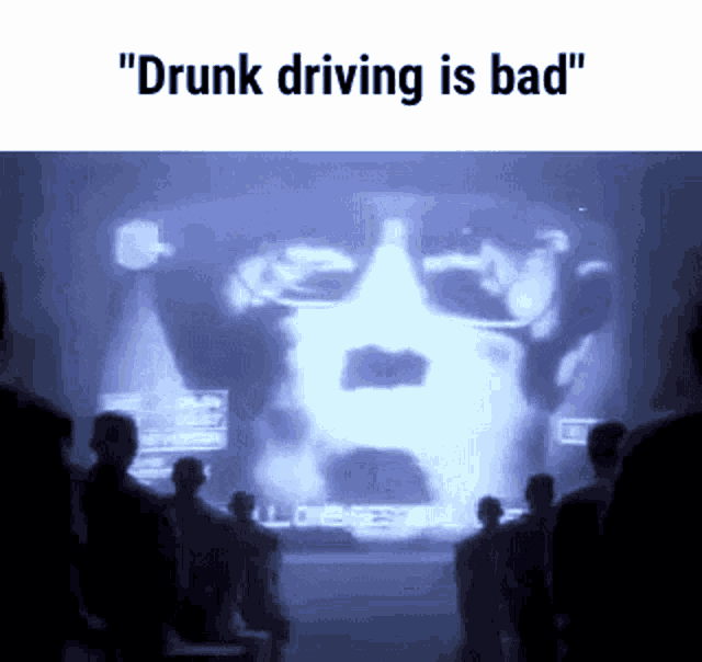 a group of people are looking at a screen that says drunk driving is bad