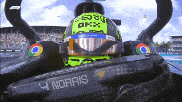 a man in a race car with the name norris on the side