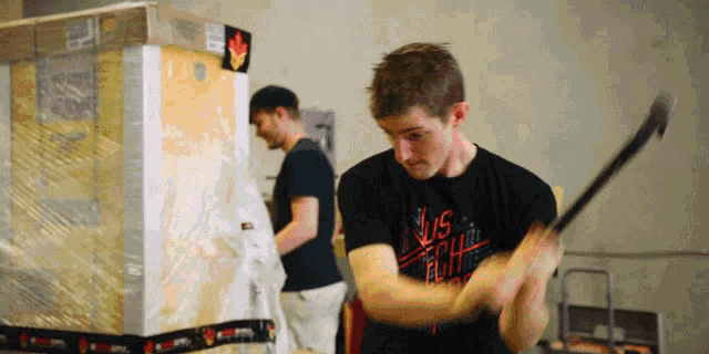 a man wearing a shirt that says ' us tech ' on it is swinging a bat