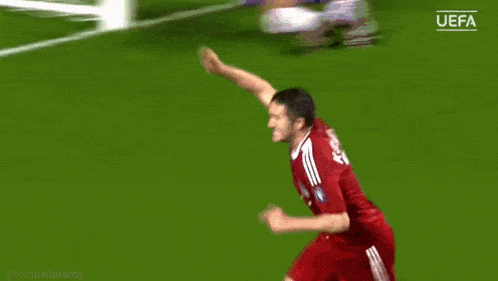 a soccer player is jumping in the air on the field