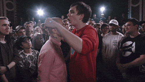 a man in a pink shirt has the number 101 tattooed on his neck