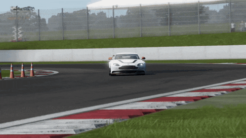 a white sports car is driving on a track