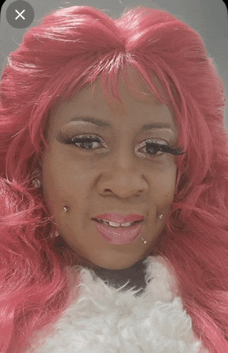 a woman with pink hair has a x on her face