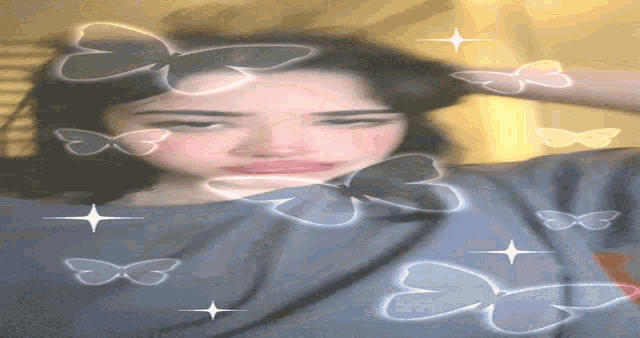 a woman laying on her back with hearts and butterflies around her head