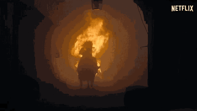 a person riding a horse in front of a fire with a netflix logo on the bottom