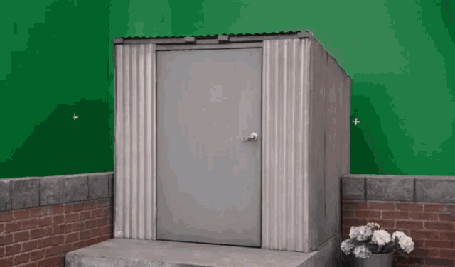 a small shed with a door and a green background
