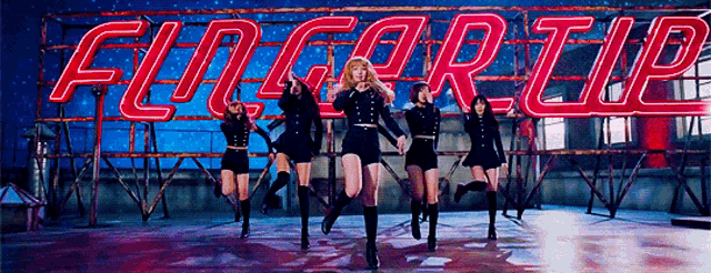 a group of women dancing in front of a sign that says floor up