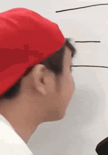 a man wearing a red hat is looking at something
