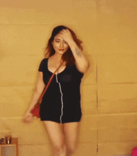 a woman wearing a black dress and a red purse