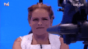 a woman stands in front of a camera that says tvi on it
