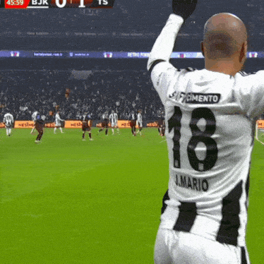 a soccer player wearing a jersey with the number 18 on the back
