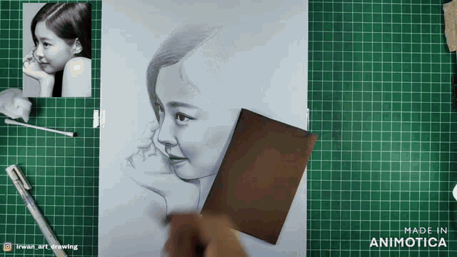 a drawing of a woman 's face is on a green cutting board made by animatica