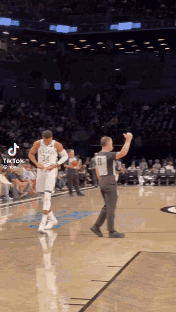 a basketball player with the number 24 on his jersey is standing on the court