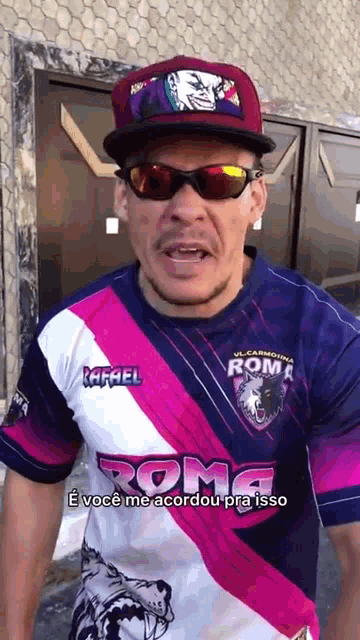 a man wearing sunglasses and a shirt with the word roma on it .