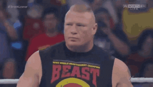 a man wearing a black tank top that says beast